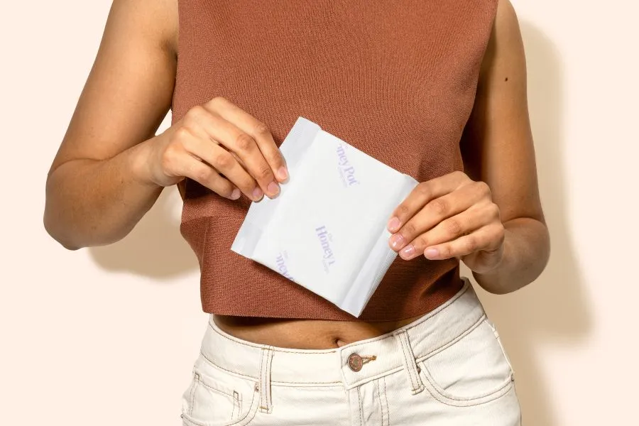 A person holding a Honey Pot pad.
